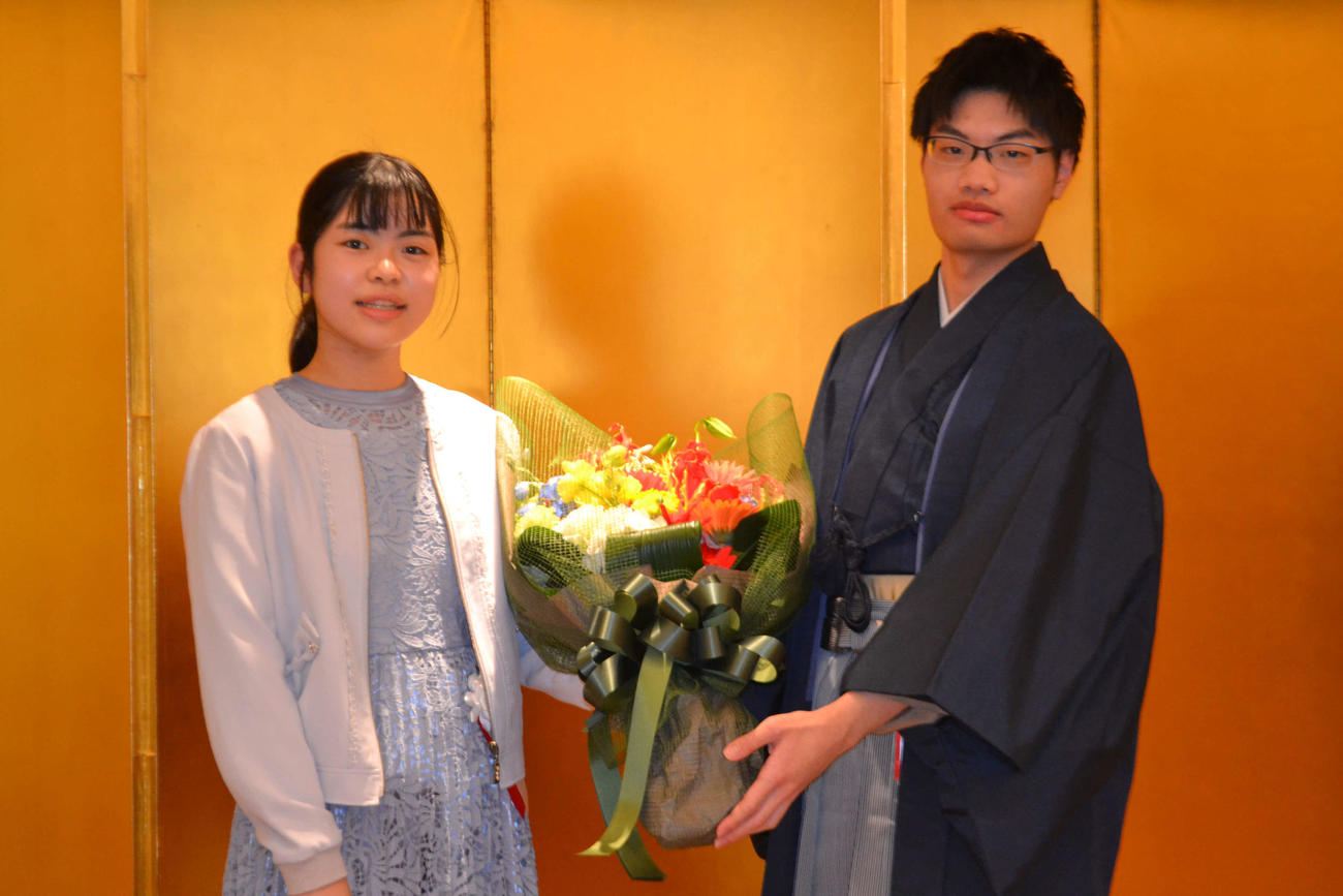 妹弟子の上野梨紗初段（左）から花束を贈呈された関航太郎天元
