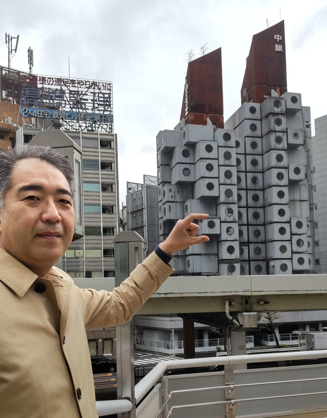 中銀カプセルタワービル保存・再生プロジェクト代表の前田達之さんに所有していた部屋をつまむようなしぐさをしてもらった（撮影・寺沢卓）