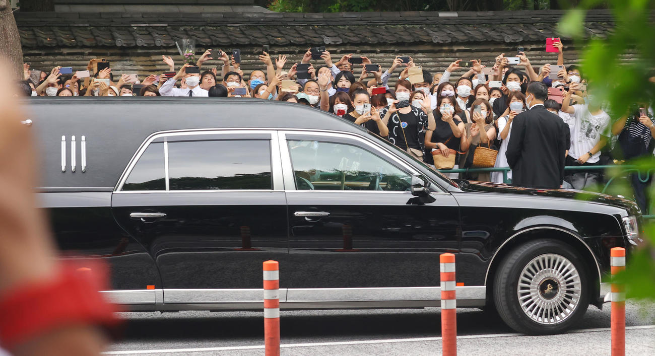 葬儀を終え、安倍元首相のひつぎを乗せた霊きゅう車を見送る人たち（撮影・野上伸悟）