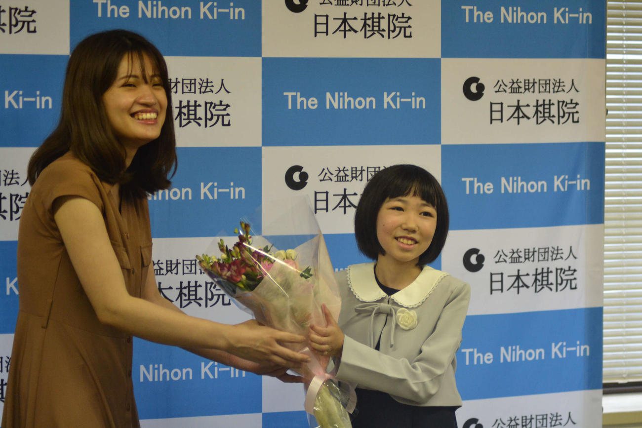 藤沢里菜女流本因坊（左）から花束を贈呈される柳原咲輝さん