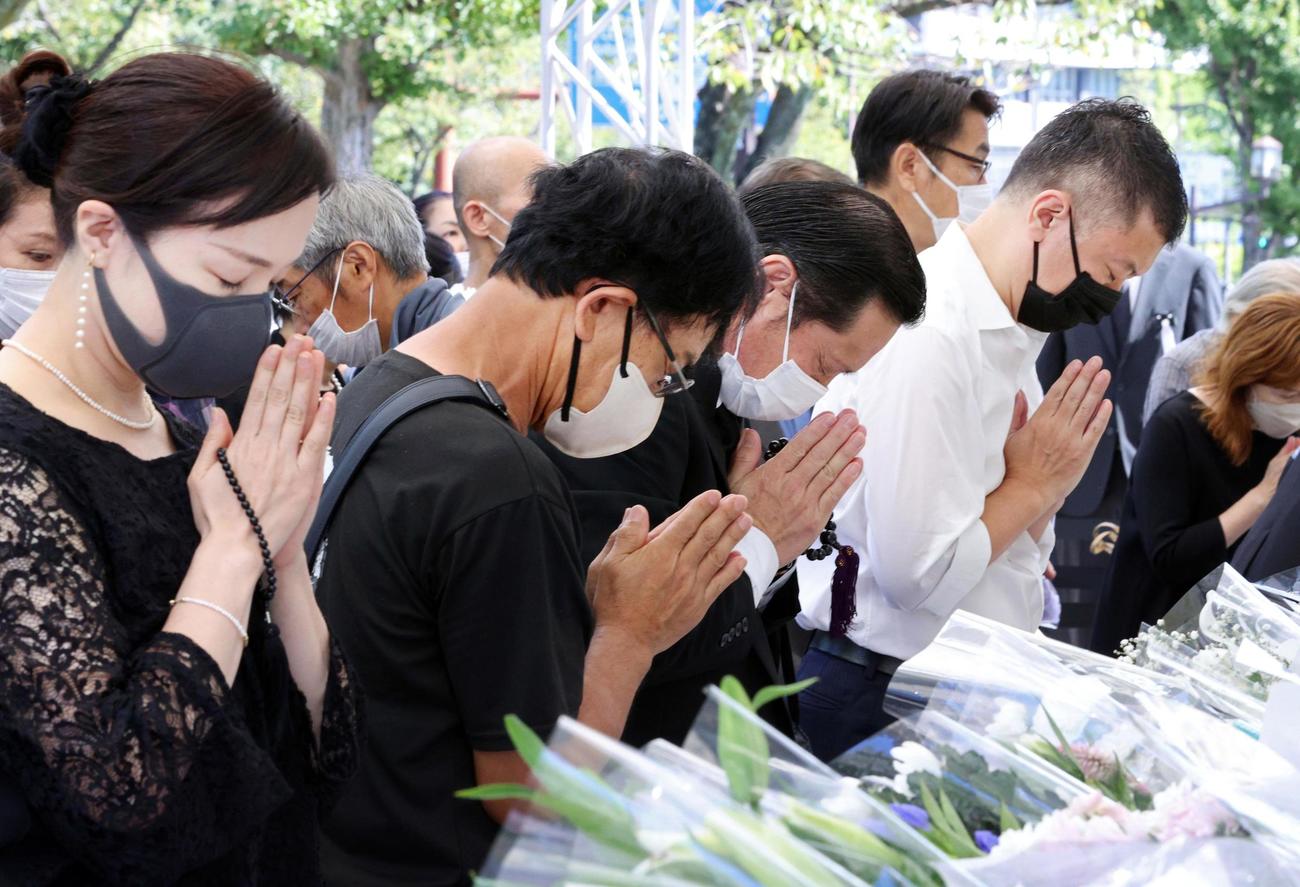 日本武道館近くに設けられた一般献花台で、手を合わせる人たち（代表撮影）
