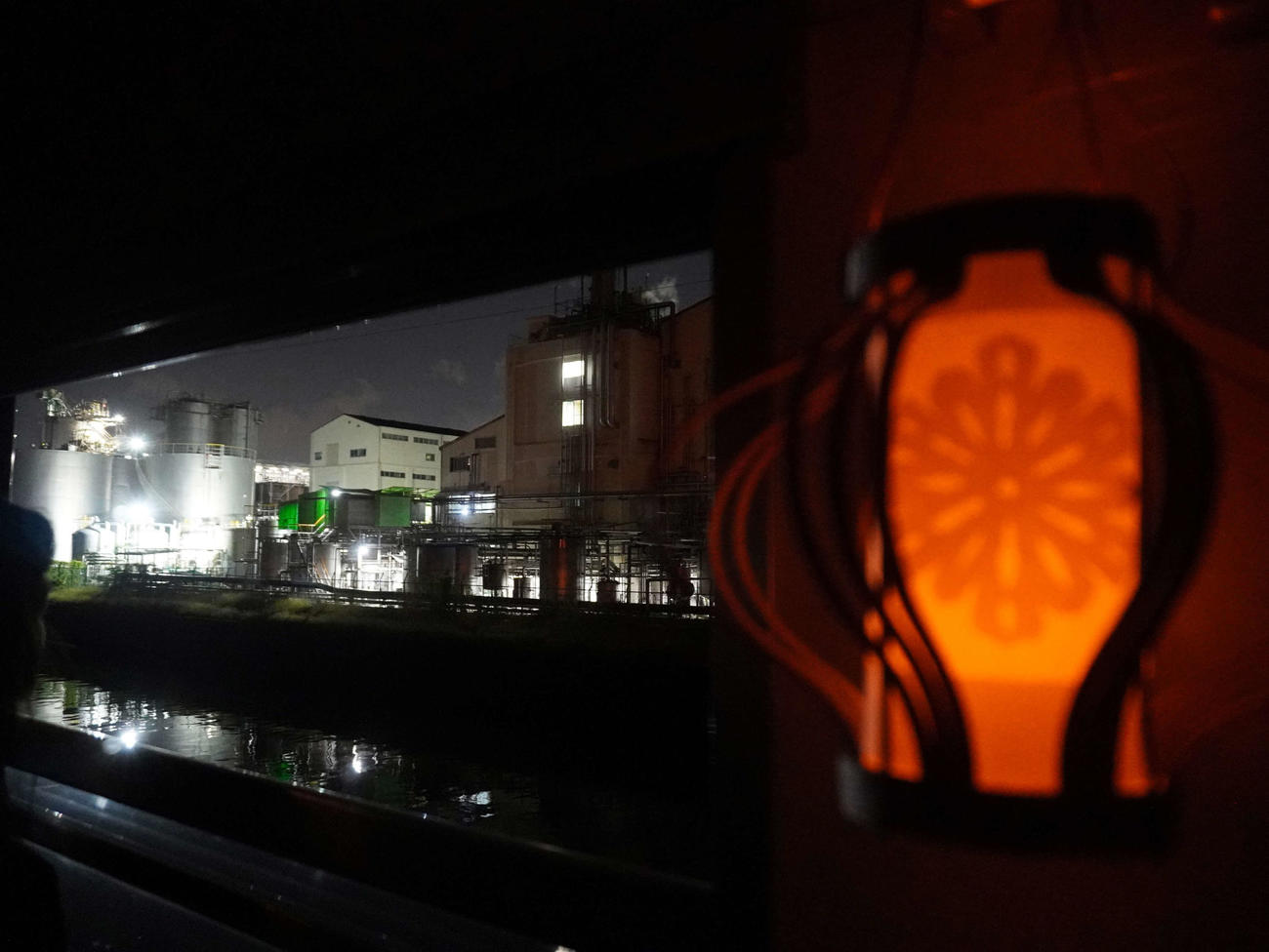 工場夜景と列車内の紙灯籠が情緒的な雰囲気を醸し出す（撮影・井上学）