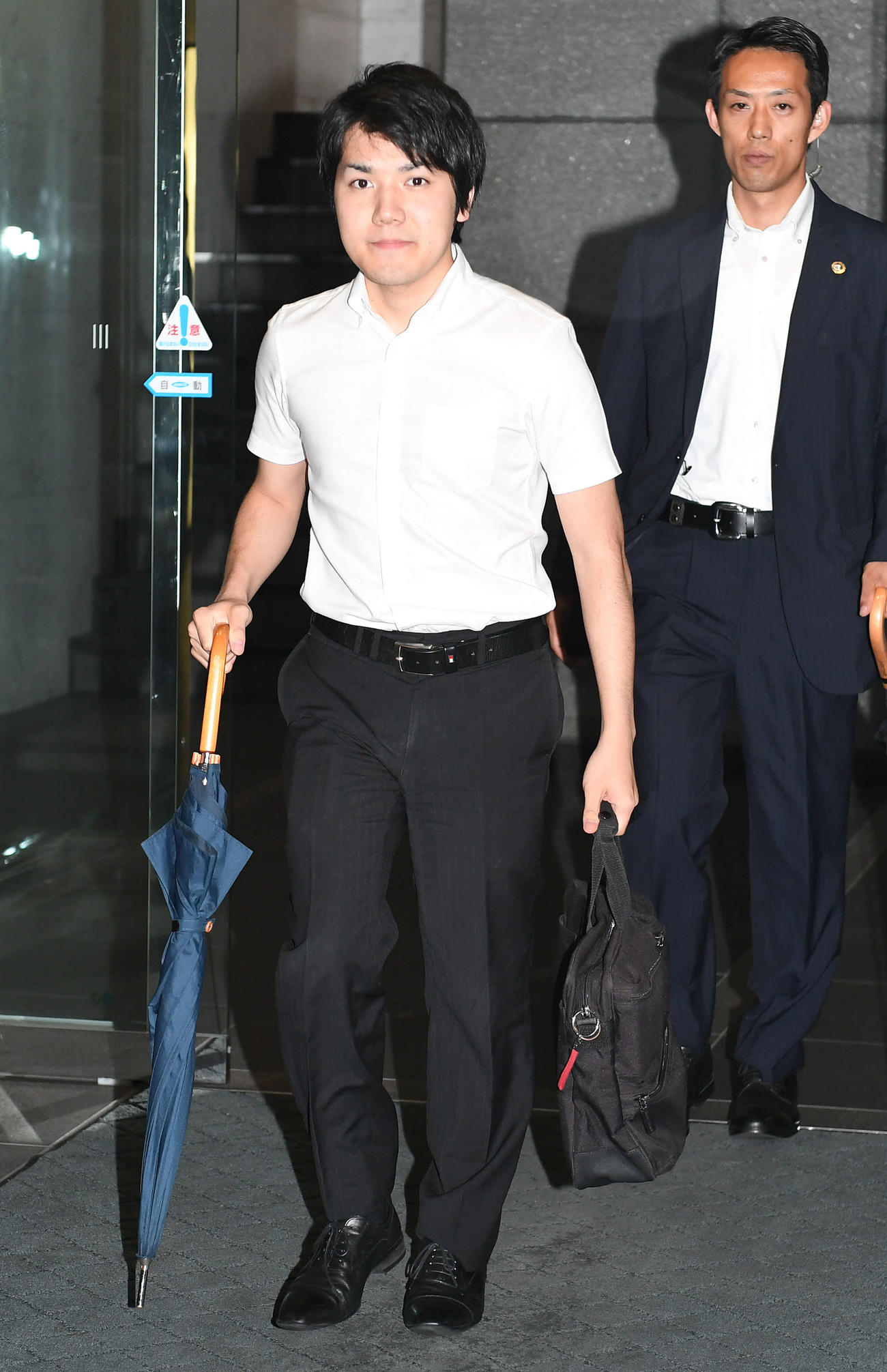 仕事を終えて帰宅の途に就く小室さん（手前）（2017年8月16日撮影）
