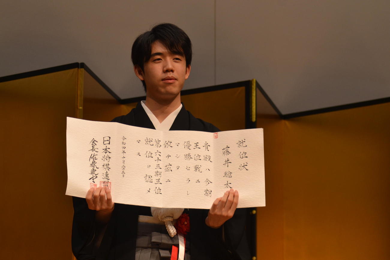 王位戦3連覇を果たして就位状を手にする藤井聡太王位