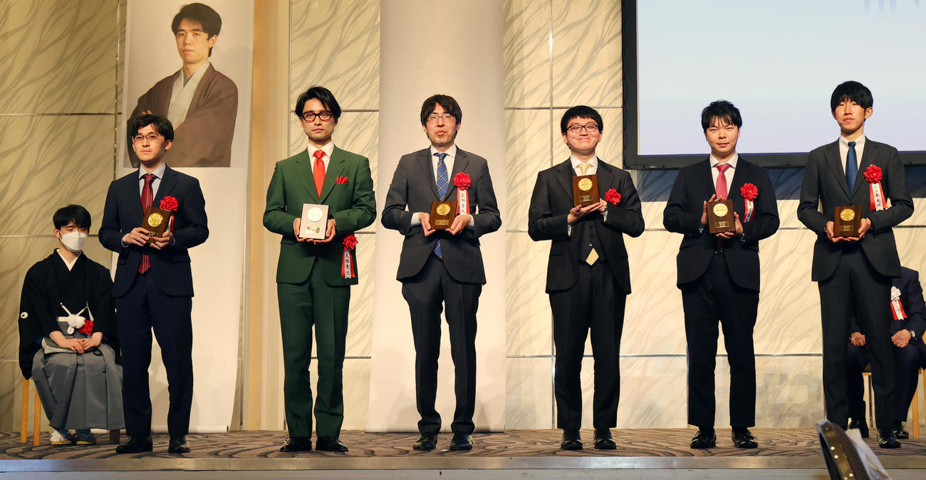 第35期竜王就位式で表彰された各組優勝者。左から6組の伊藤五段、4組の大橋六段、2組の広瀬八段、1組の永瀬王座、3組の高見七段、5組の佐々木七段。後方左は藤井竜王（撮影・野上伸悟）