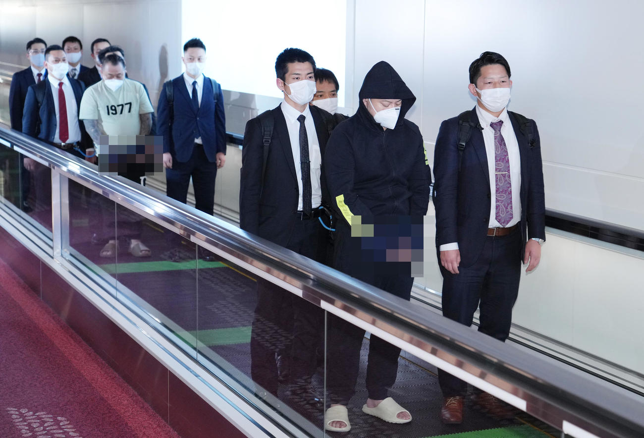 フィリピンのマニラから強制送還され日本に到着した渡辺優樹容疑者（前方中央）と小島智信容疑者（後方中央）（写真は一部加工）（写真は一部加工）（撮影・菅敏）