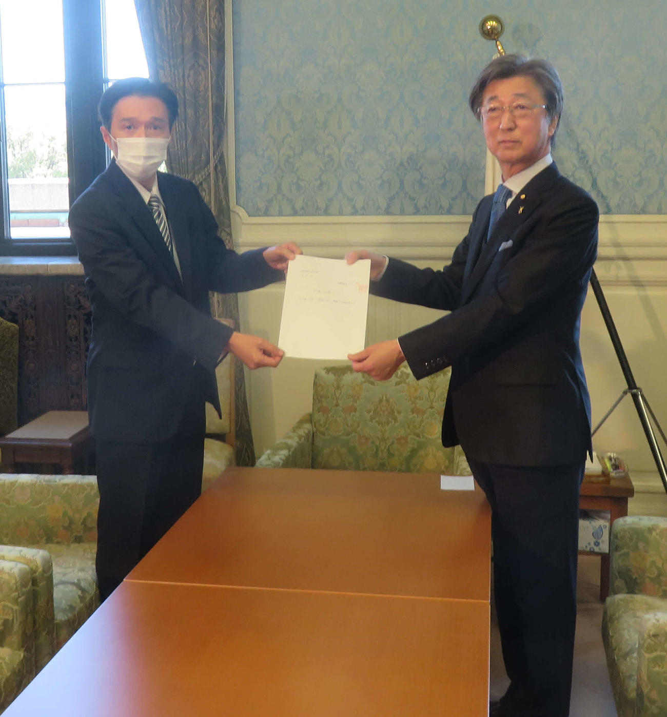 石井準一議院運営委員長（右）にNHK党のガーシー参院議員の渡辺文久秘書から帰国して「議場での陳謝」に応じる文書が手渡された（撮影・大上悟）