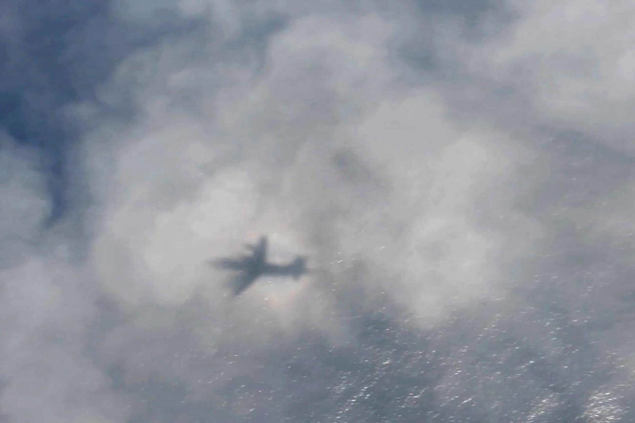 潜水艇を捜索するカナダ空軍飛行隊の影が雲に覆われる（ロイター）