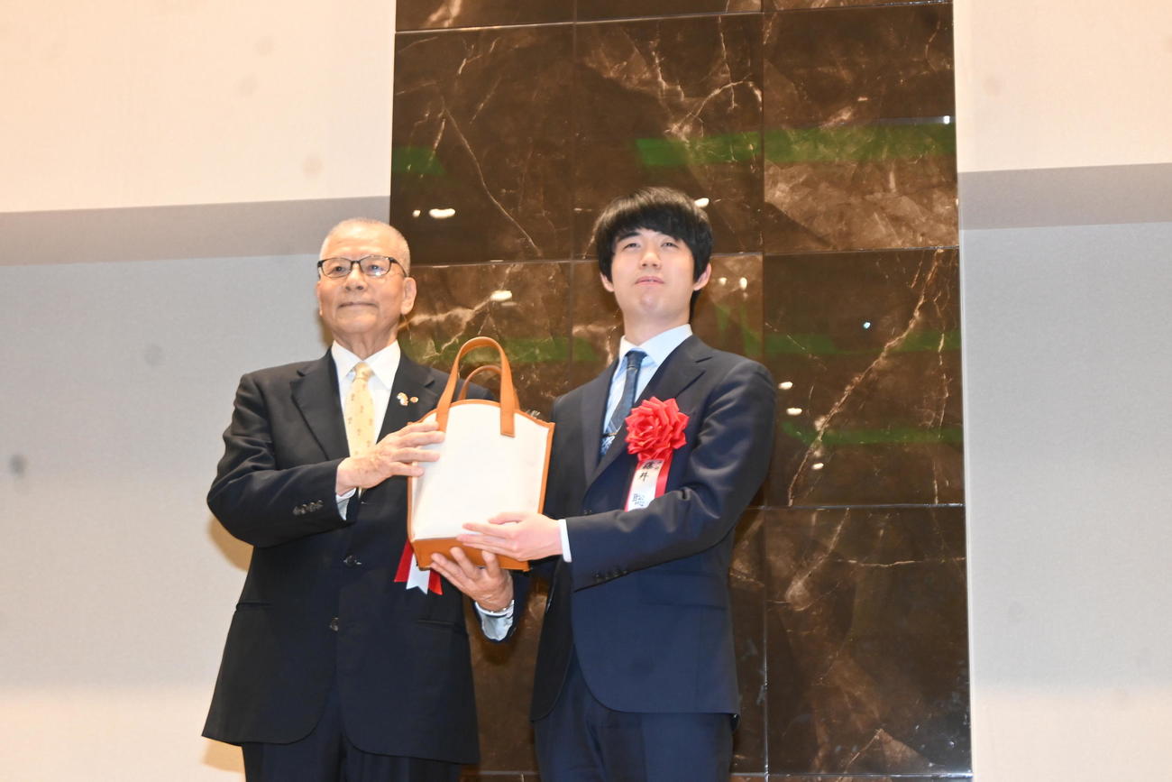 高槻市の特産品などの詰め合わせをプレゼントされた藤井聡太王将（撮影・松浦隆司）