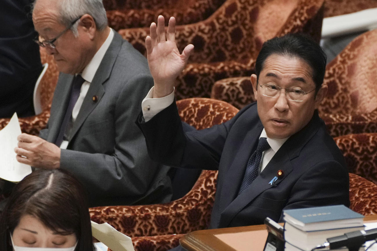 衆院予算委の集中審議で、答弁のため挙手する岸田首相（共同）