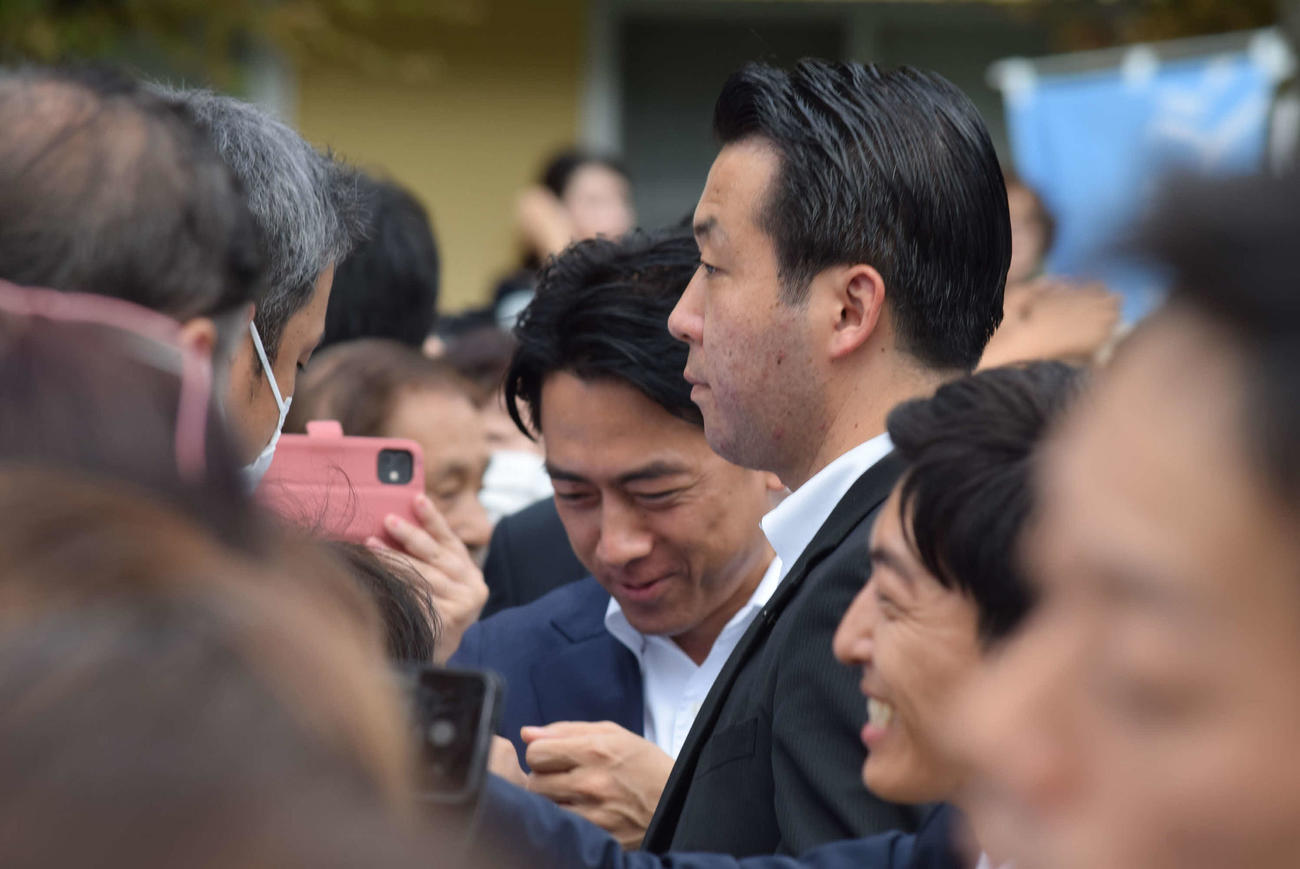 ものものしい警備の中、支援者とグータッチする小泉進次郎氏（撮影・阪口孝志）