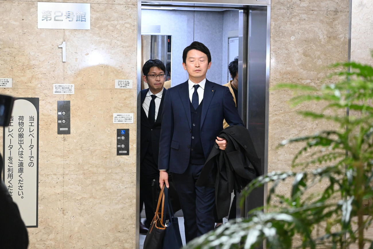 退庁の際に報道陣の取材に応じるため、ロビーに向かう斎藤元彦知事（撮影・松浦隆司）
