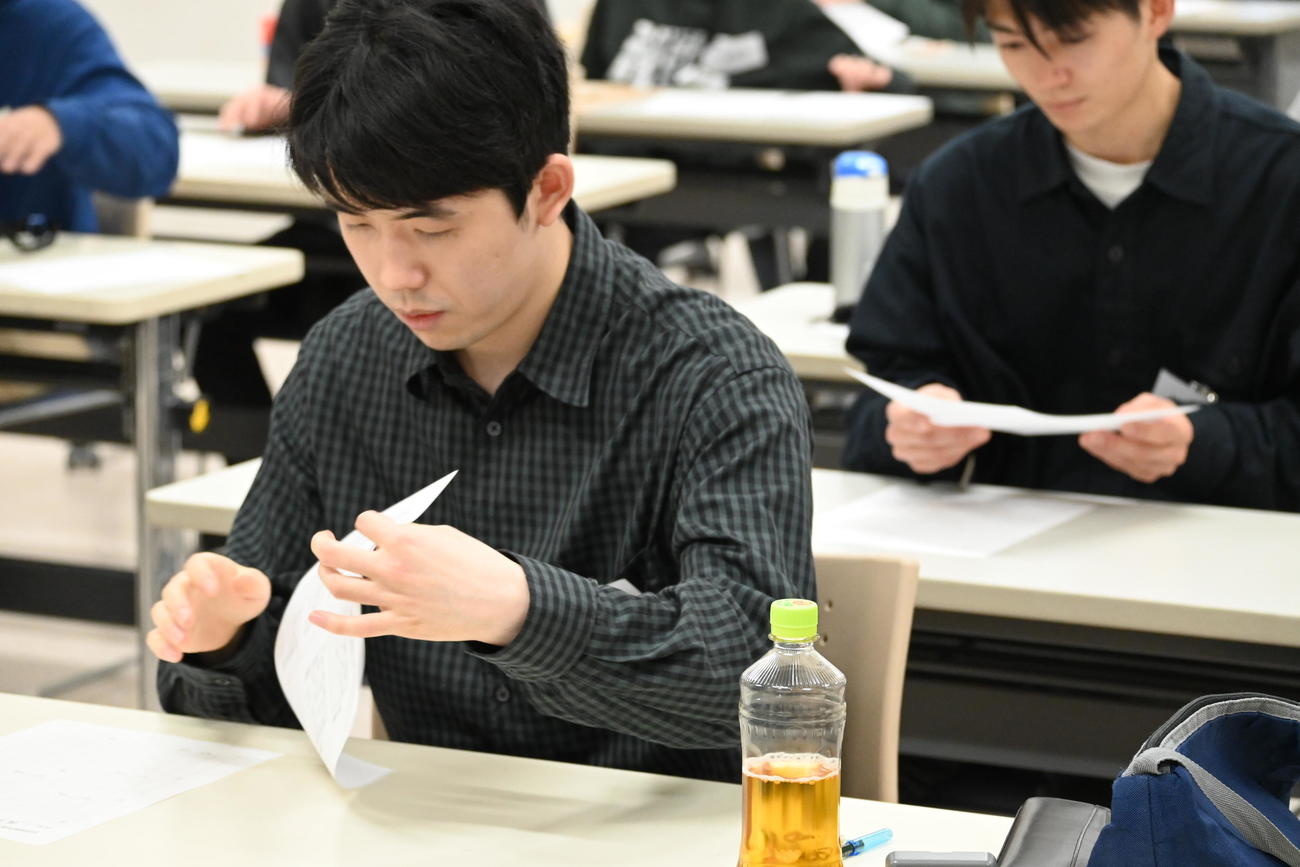 午後の第2Rで問題用紙をめくる藤井聡太7冠（撮影・松浦隆司）