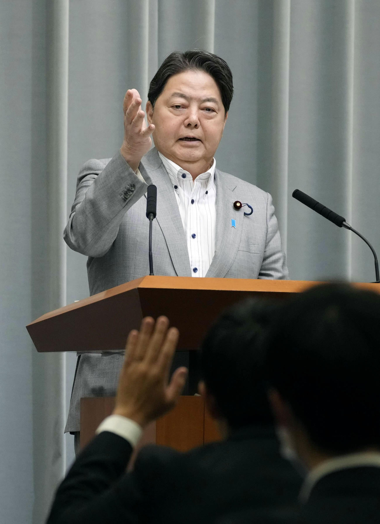 19日午前、記者会見する林官房長官（共同）