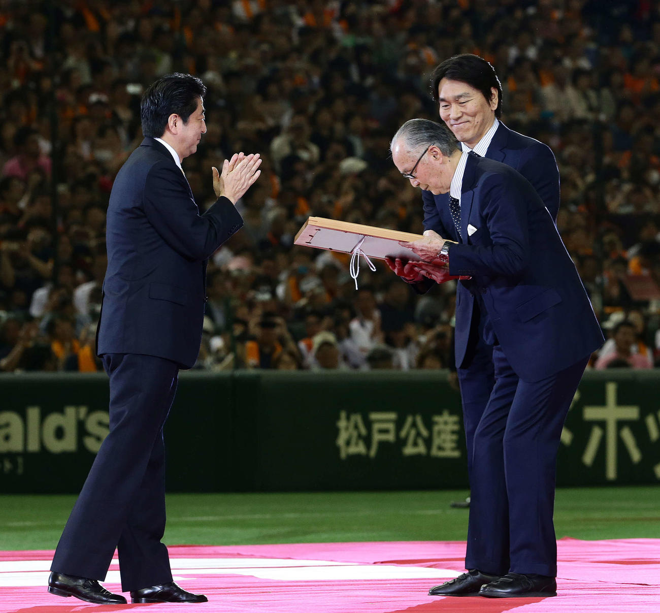 安倍首相（左）から国民栄誉賞の表彰状を授与される長嶋氏。後方は介添えする松井氏（撮影・江口和貴）