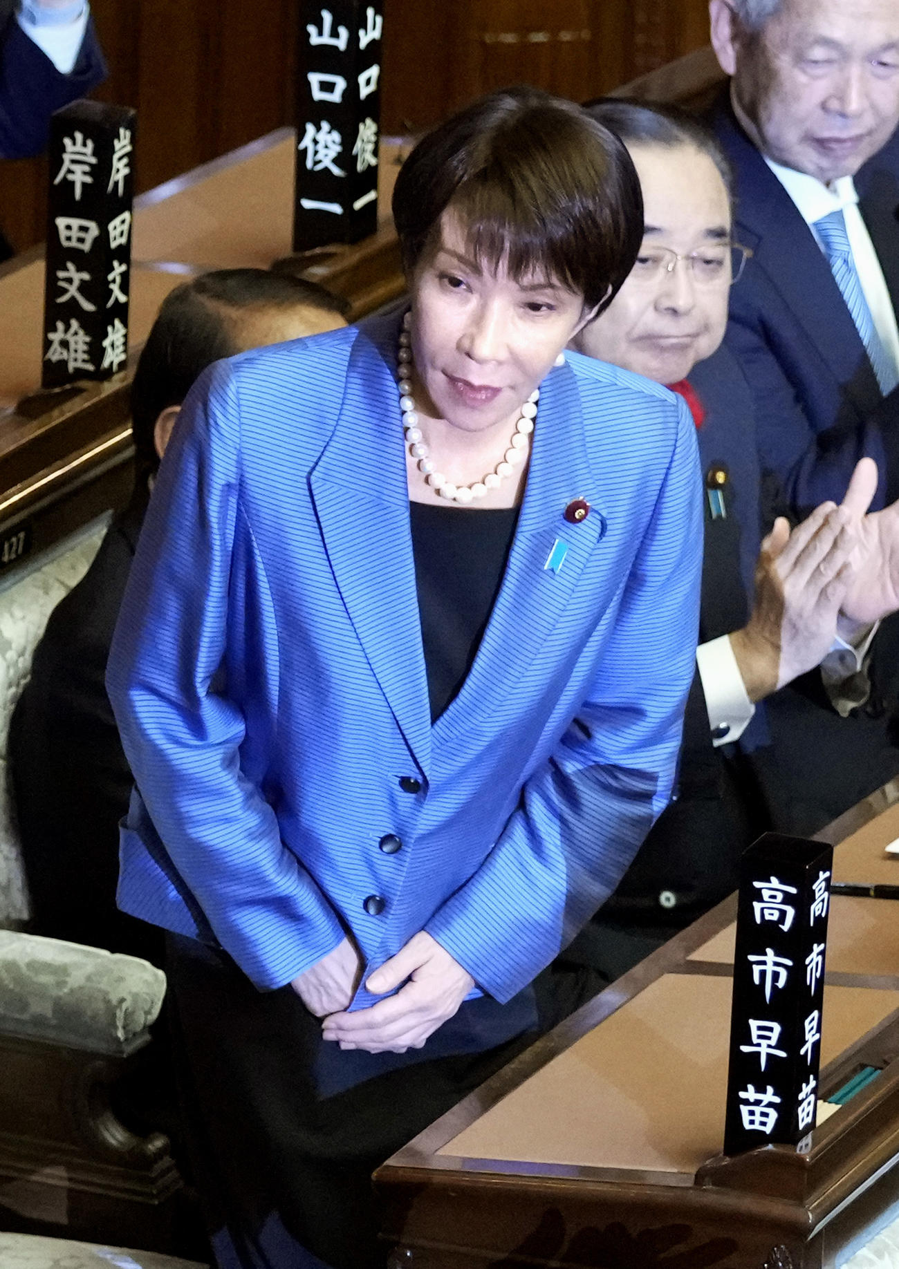 院本会議で第104代首相に指名され、起立する自民党の高市早苗総裁。憲政史上初となる女性首相が誕生した（共同）