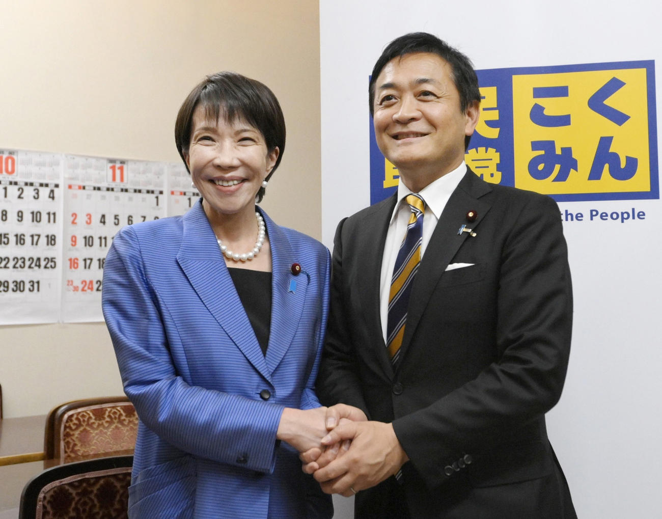 あいさつ回りで国民民主党の玉木雄一郎代表（右）と握手する高市早苗首相（共同）