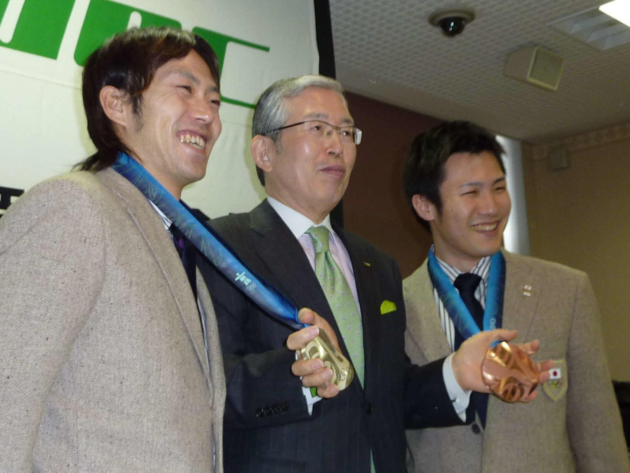 日本電産サンキョーの永守重信会長（中央）にメダル獲得を報告する長島圭一郎（左）加藤条治（右）（10年3月3日撮影）