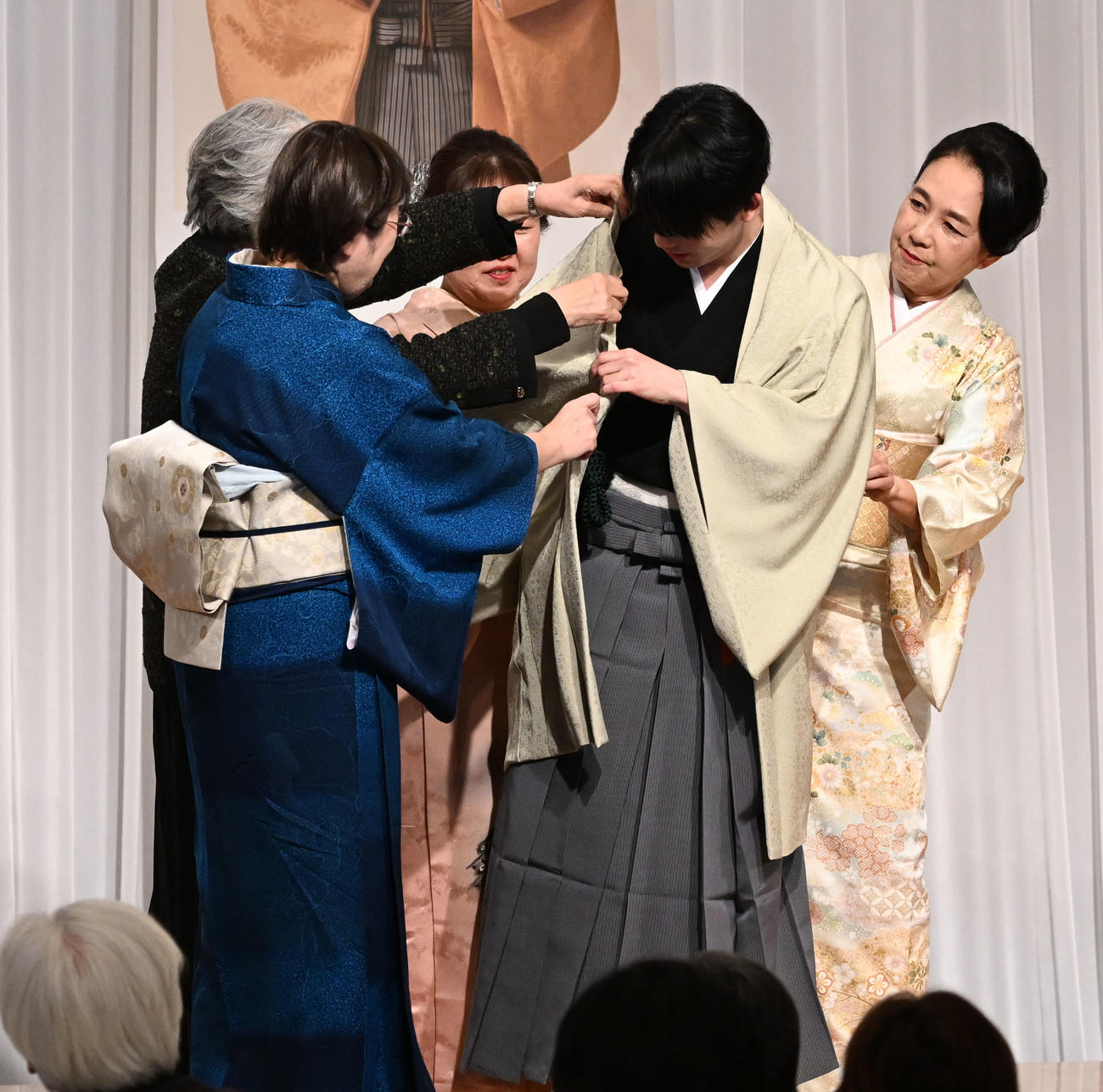 第38期竜王就位式　クラウドファンディングの支援者に贈られた記念の羽織を着せてもらう藤井竜王（撮影・千葉一成）