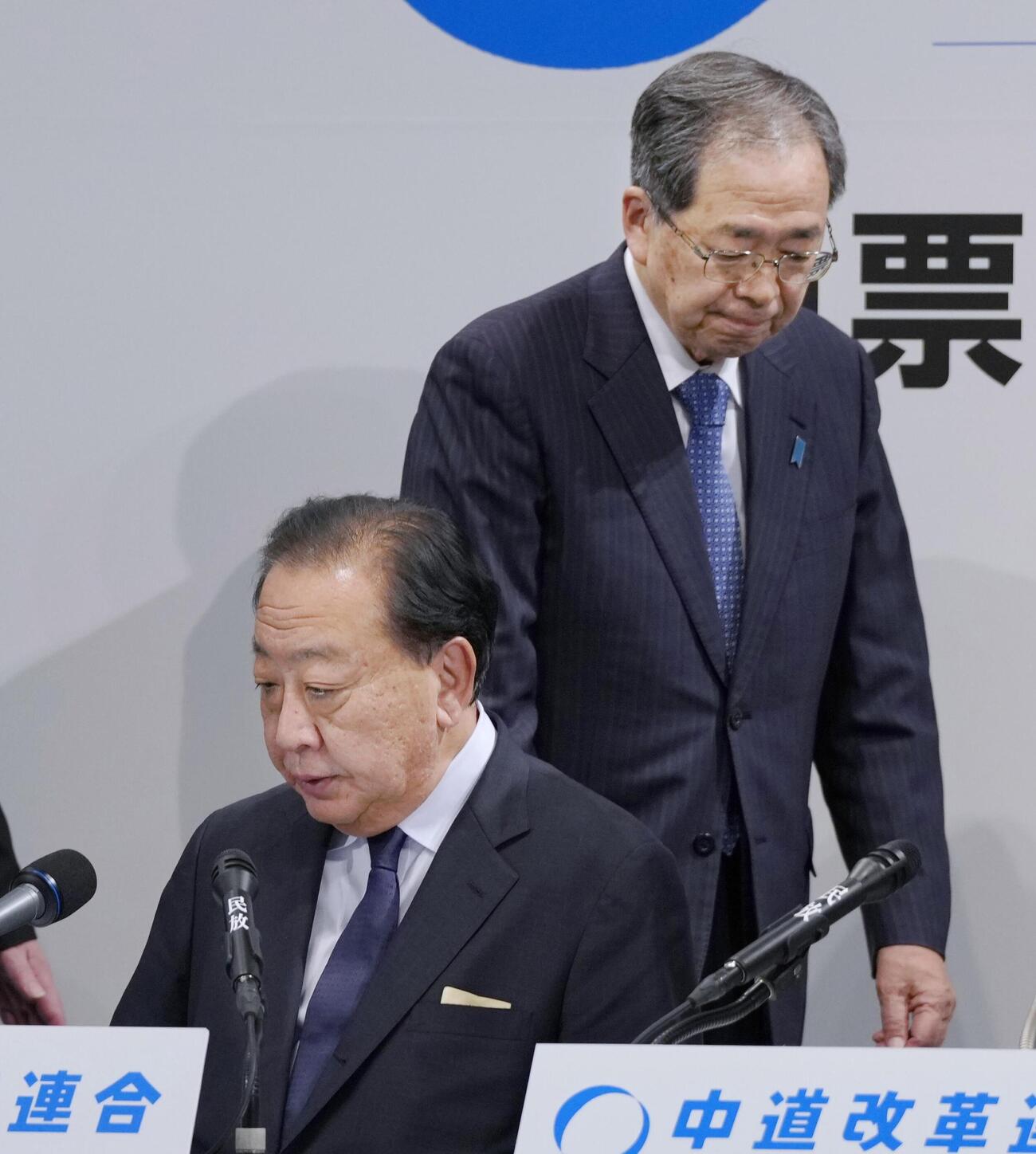 厳しい表情でメディアのインタビューに臨む中道改革連合の野田共同代表（左）と斉藤共同代表（共同）