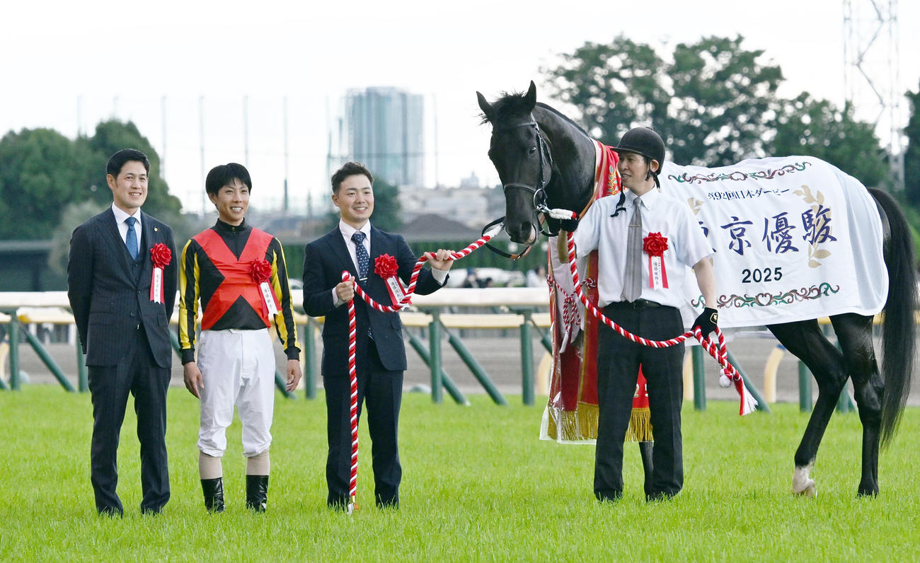 日本ダービーをクロワデュノールで制し、口取り式に臨む北村友騎手と斉藤崇師（左端）