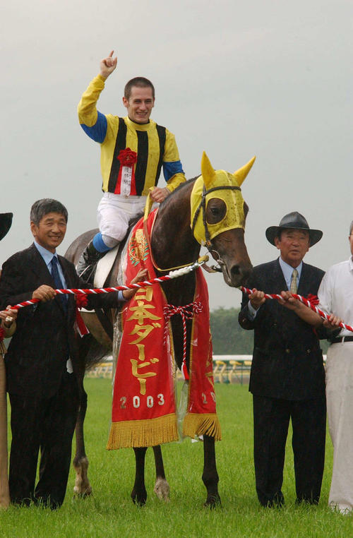 03年ダービーをネオユニヴァースで制したミルコ・デムーロ騎手、左は吉田照哉オーナー、右は瀬戸口調教師