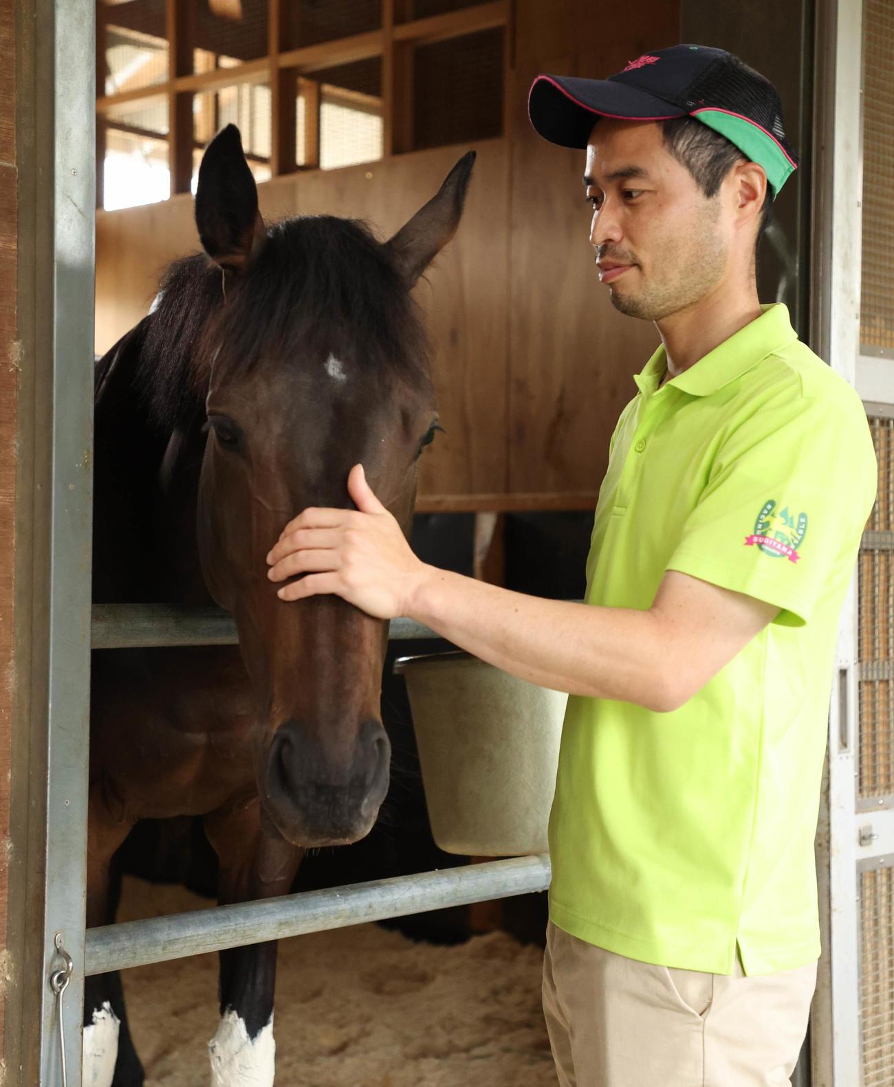 デアリングタクトの顔をなでる杉山晴師