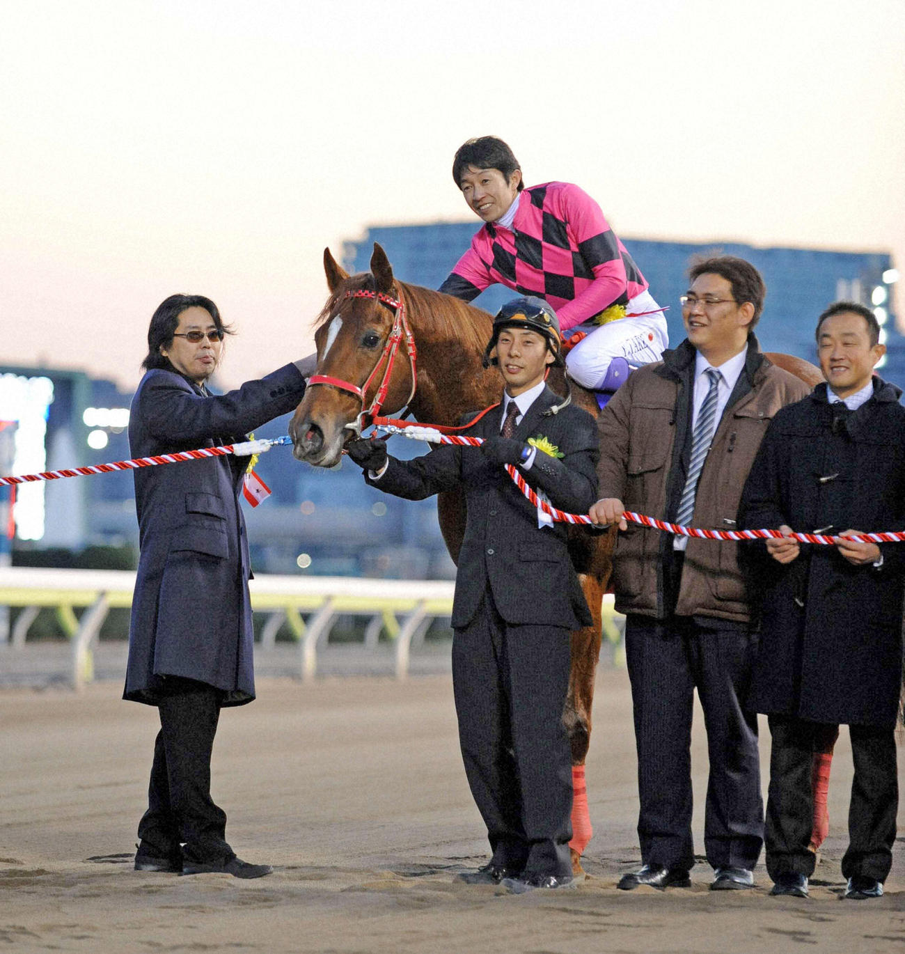 11年12月、東京大賞典を制したスマートファルコン騎乗の武豊騎手は大川徹馬主と握手を交わす