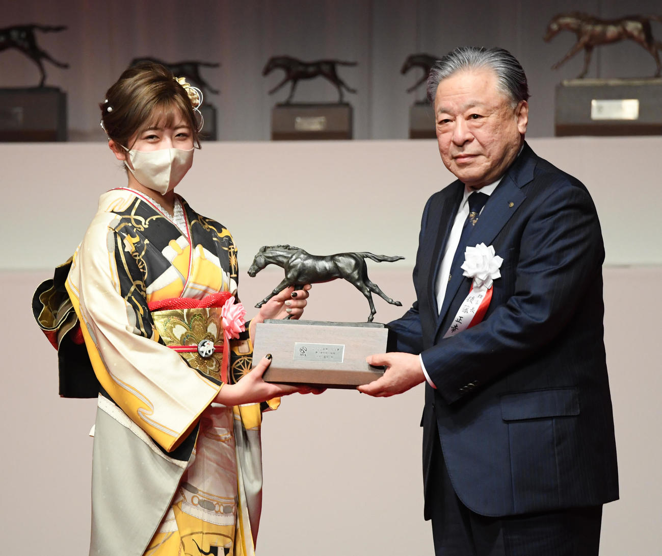 最多勝利新人騎手に選ばれた今村騎手（左）は後藤JRA理事長からトロフィーを贈られた（撮影・柴田隆二）