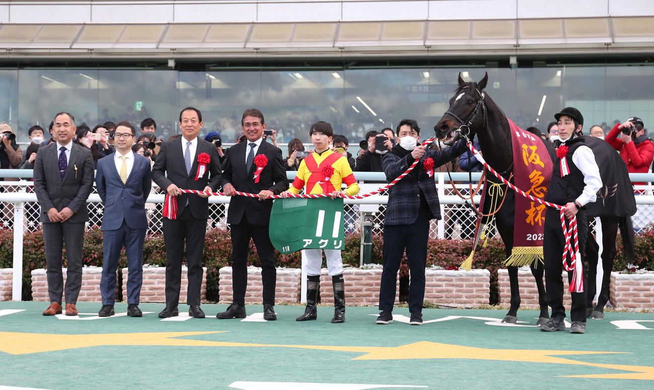 4連勝で阪急杯を制したアグリと口取りに並ぶ横山和騎手（右から3人目）（撮影・白石智彦）