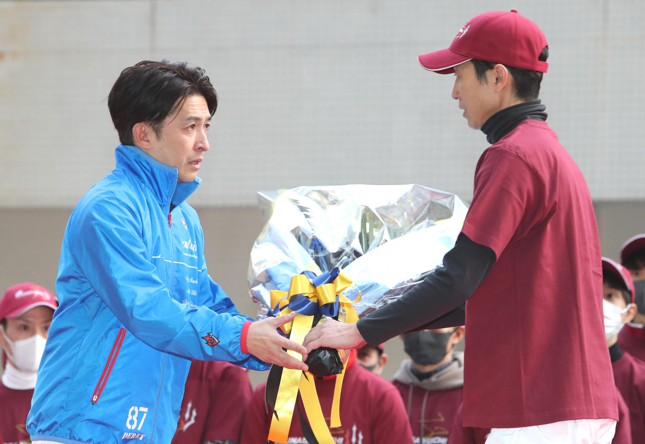 引退セレモニーで武豊騎手（右）から花束を受け取る福永元騎手（撮影・白石智彦）