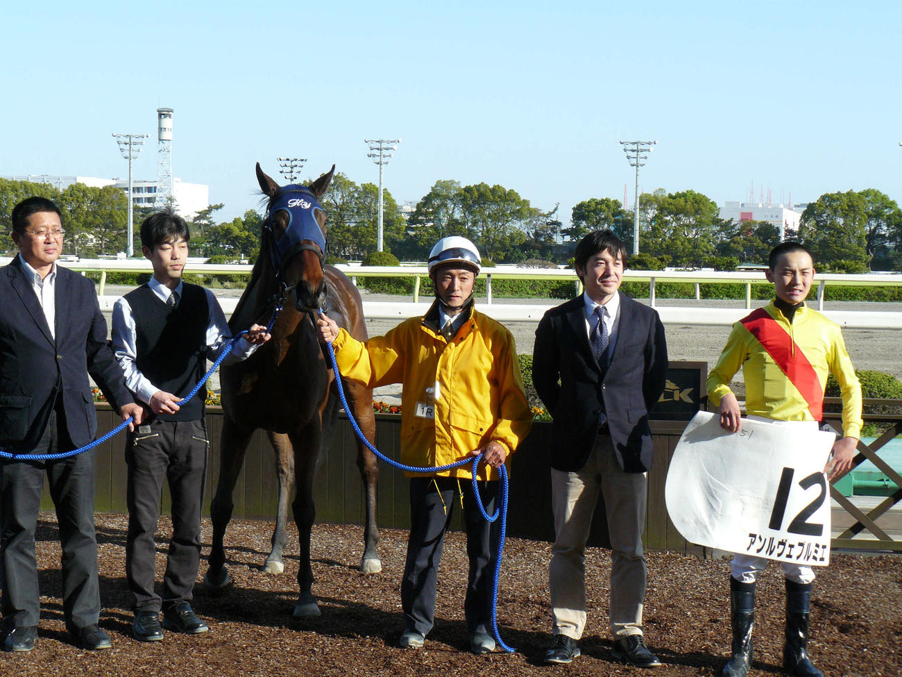 待望の初勝利を挙げ関係者と記念撮影する笹川翼騎手（右端）（2013年4月9日撮影）