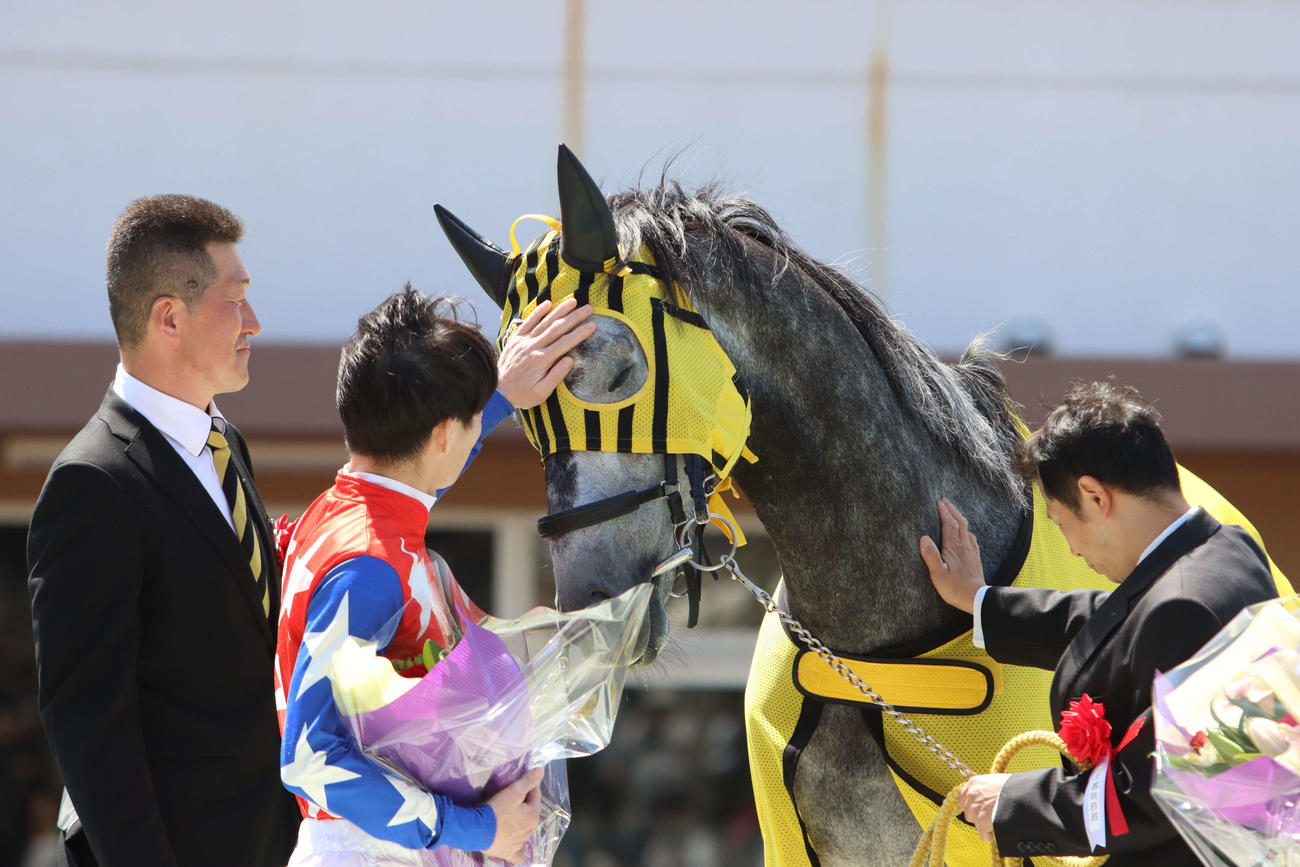 引退式でミューチャリーの顔をなでる御神本訓史騎手（左から2人目）