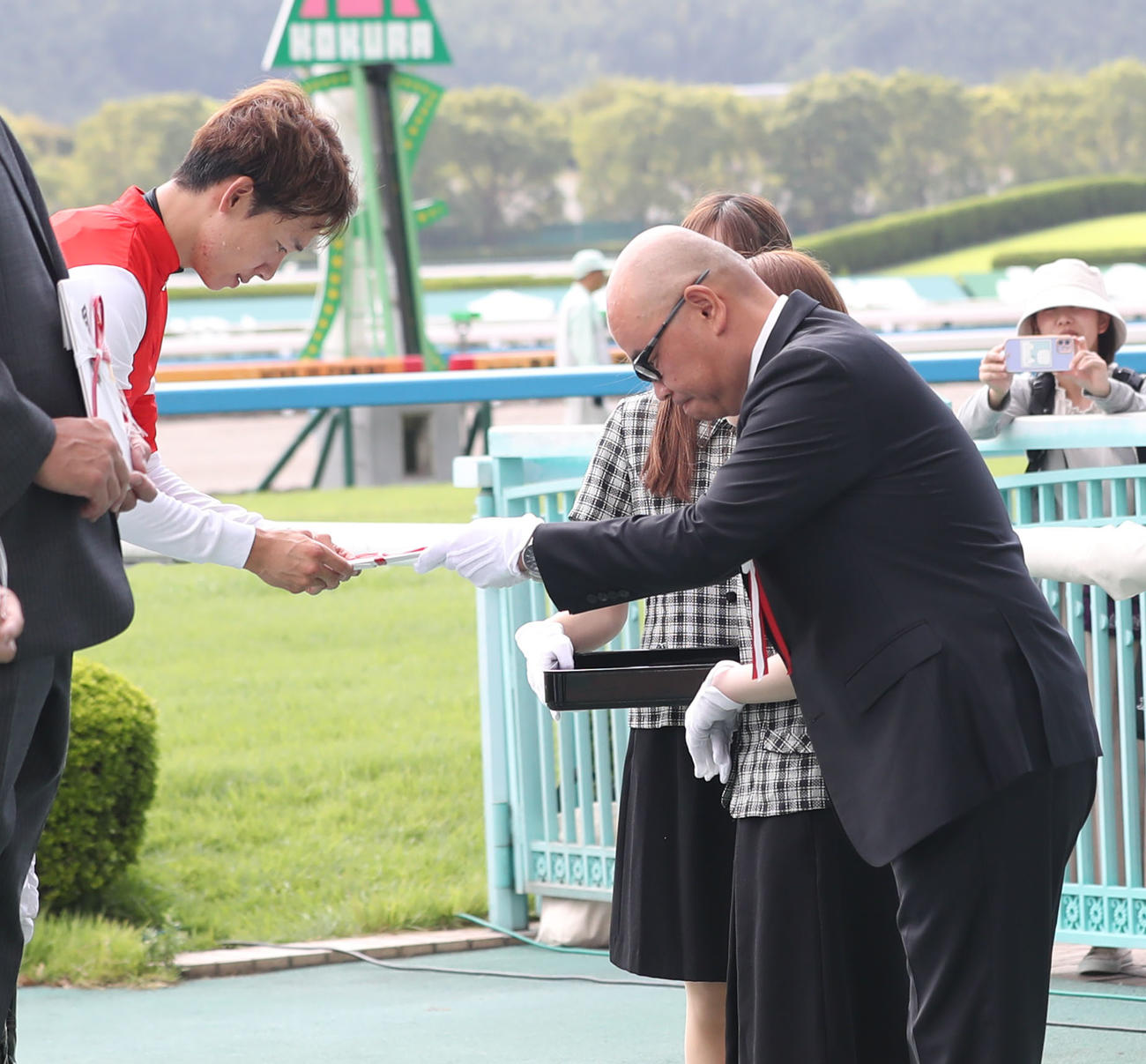 西部日刊スポーツ杯を制した松山騎手（左）に目録を手渡す浜崎西部本社代表（撮影・冨田成美）