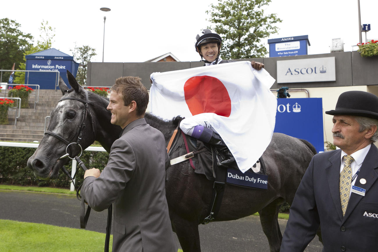 シャガーCで勝利しイルドレの鞍上で日の丸を掲げて笑顔の武豊騎手（2011年8月6日撮影）