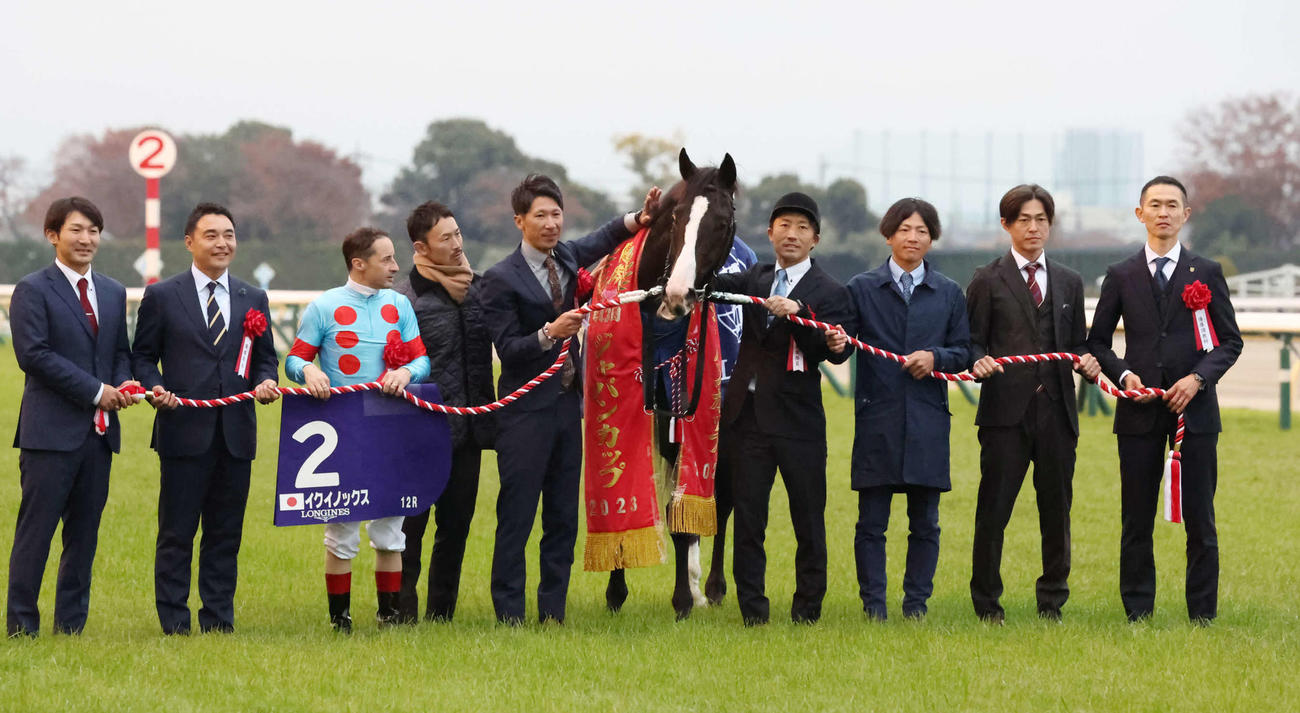 26日、ジャパンCを制したイクイノックスの口取りをするルメール騎手と木村師（右端）