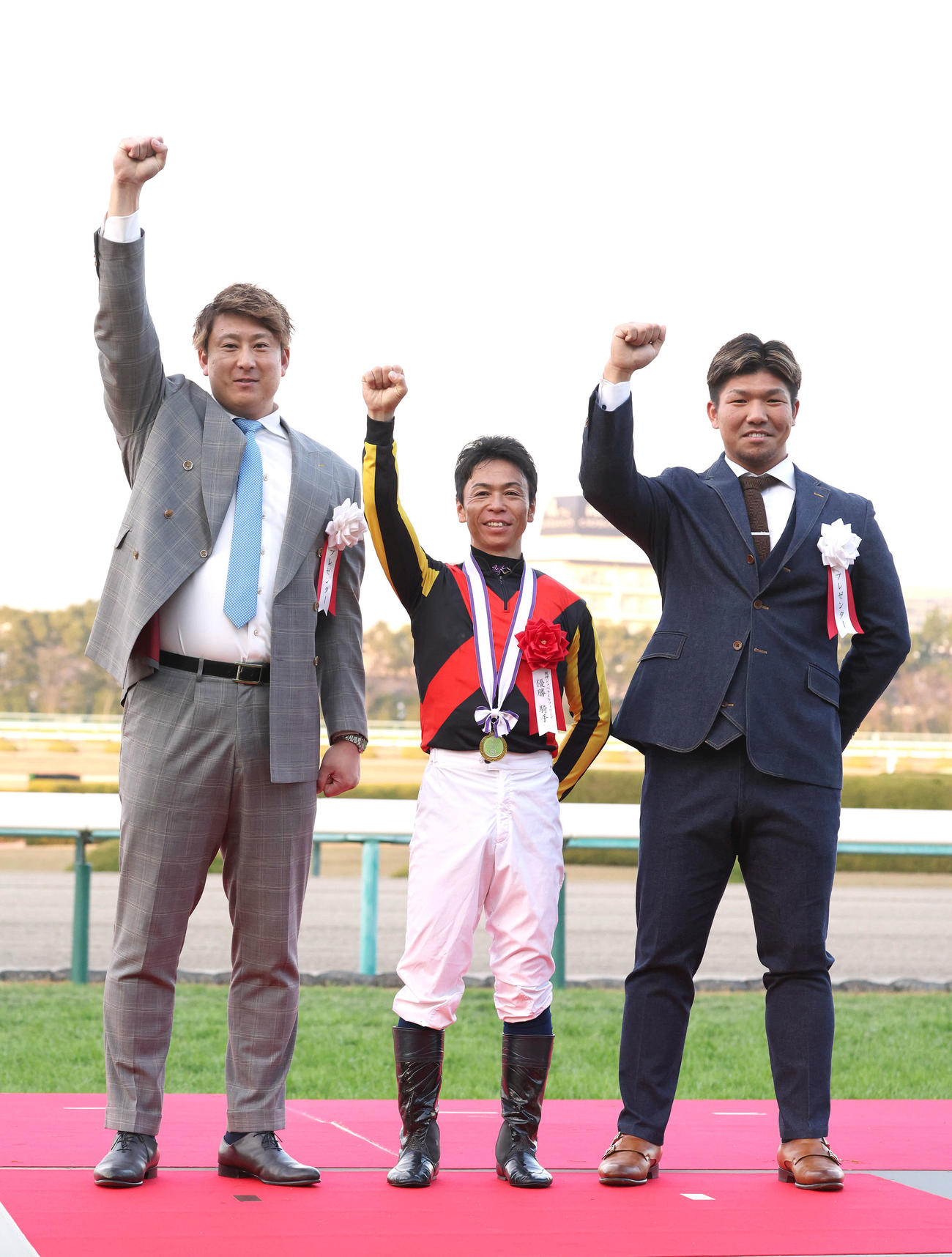 阪神JFを制し、プレゼンターのオリックス杉本（左）と昇天ポーズの北村宏騎手（中央）（撮影・白石智彦）