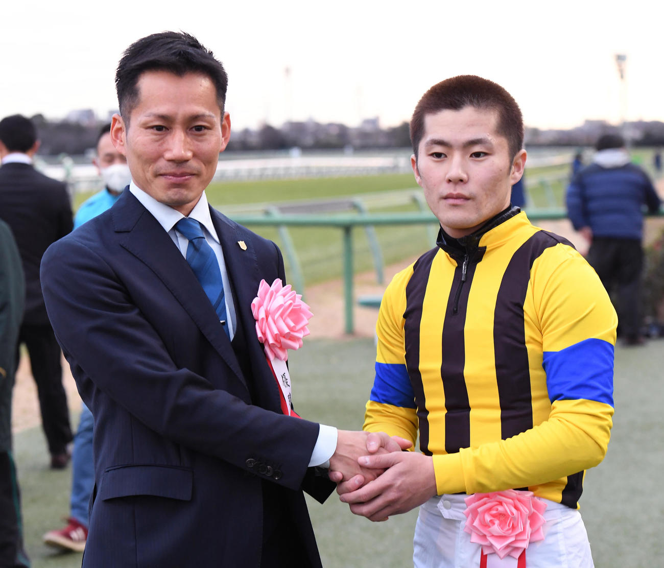 フェアリーSを制したイフェイオンの西村淳騎手（右）は杉山佳調教師と握手する（撮影・柴田隆二）