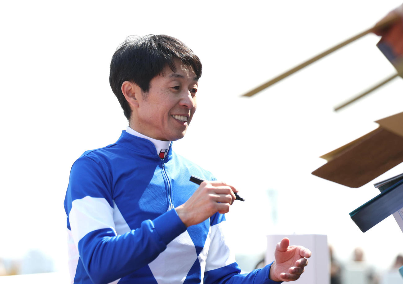 グランオースで阪神2Rを勝利してファンにサインする武豊騎手（撮影・白石智彦）