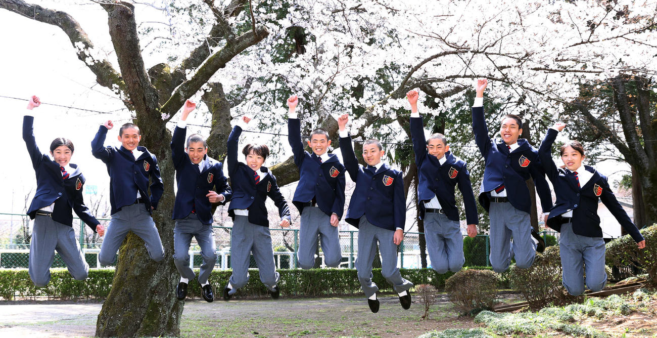 JRA競馬学校入学式で桜をバックにジャンプする。左から萱野花音さん、川原謙心君、竹島英騎君、田中美海さん、谷原圭大君、千引陸君、藤田悠輔君、幸大斗君、山田仁菜さん（撮影・柴田隆二）
