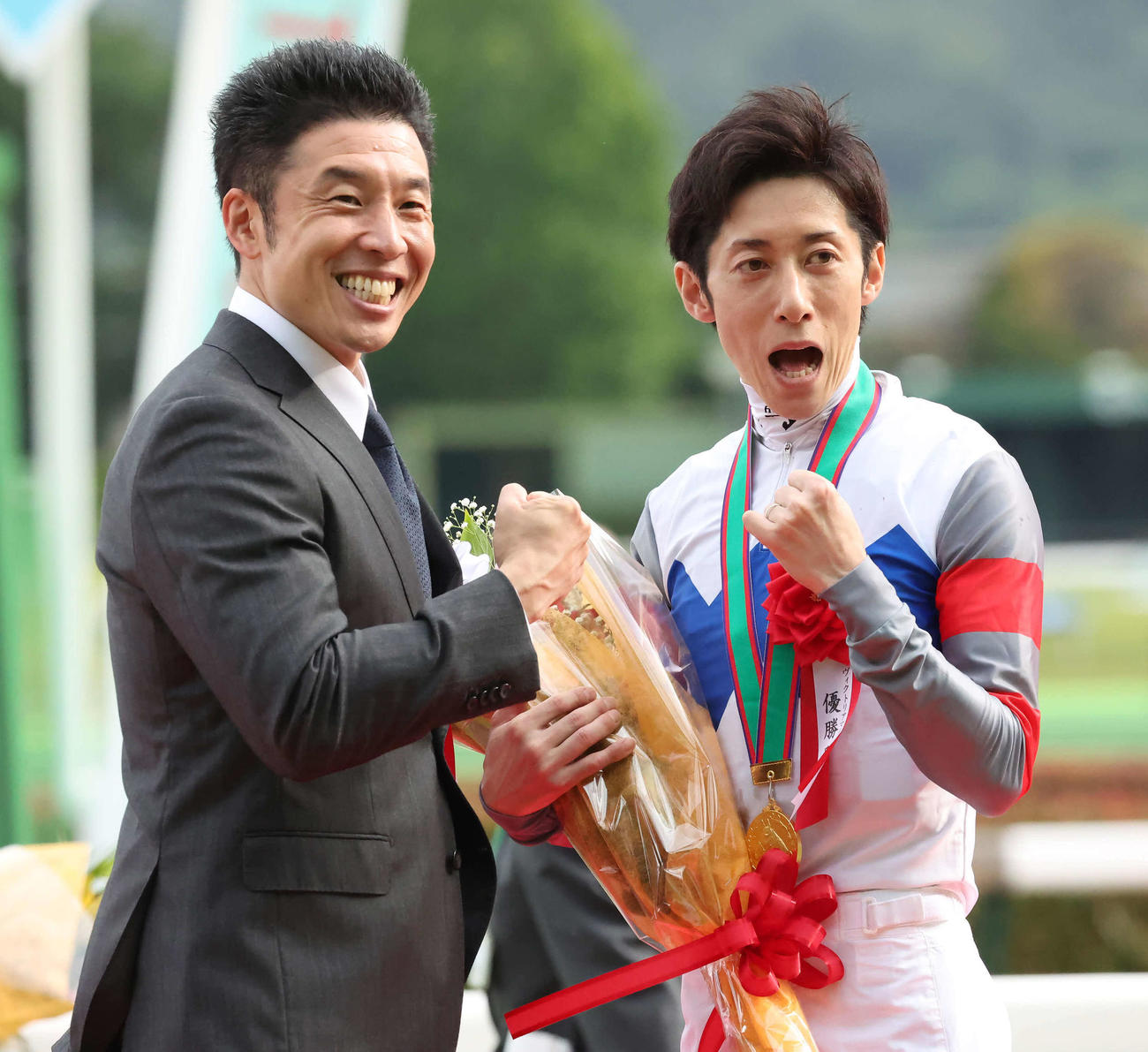 プレゼンターのなかやまきんに君と「パワー！」ポーズを決める津村騎手（撮影・丹羽敏通）