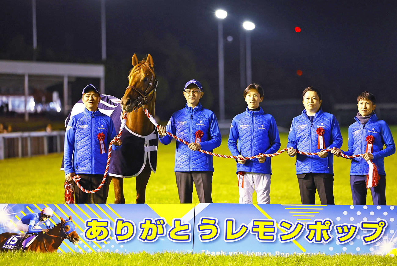 引退式で記念写真に納まるレモンポップと坂井騎手（右から3人目）ら関係者（撮影・藤尾明華）