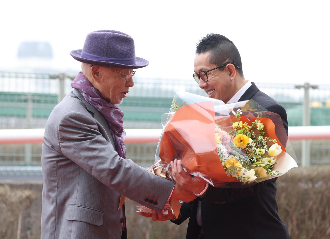 阪神7R、勇退する村山師（右）に花束を渡す小林祥晃氏（撮影・白石智彦）