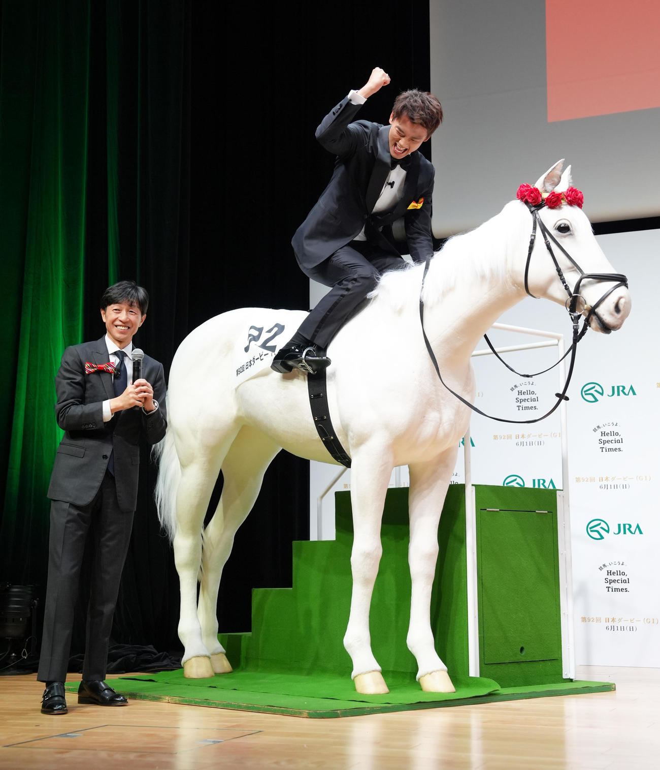 「馬ロボ」に騎乗しガッツポーズする竹内涼真（右）。左は武豊騎手（撮影・足立雅史）