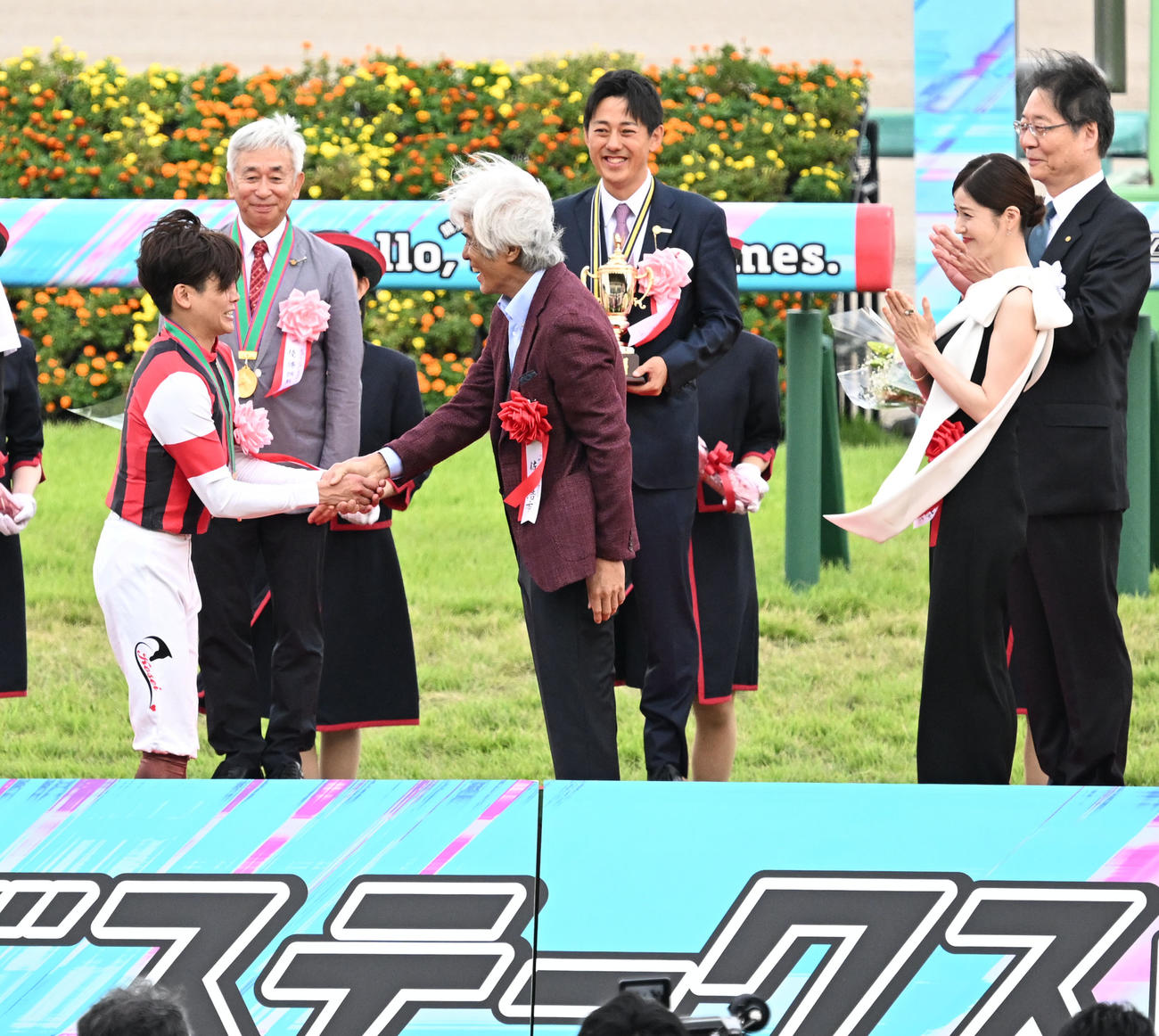 スプリンターズSの表彰式で、佐藤浩市（右）から祝福される三浦騎手（撮影・千葉一成）
