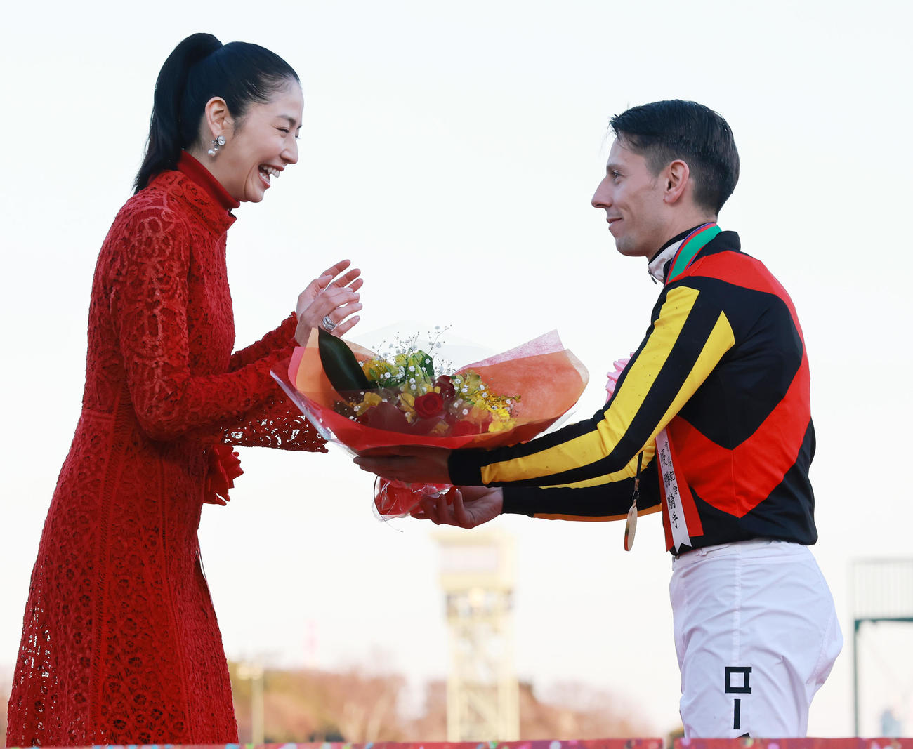 有馬記念をミュージアムマイルで制したCデムーロ騎手（右）は、記念撮影後にもらった花束を長澤まさみにプレゼント（撮影・野上伸悟）