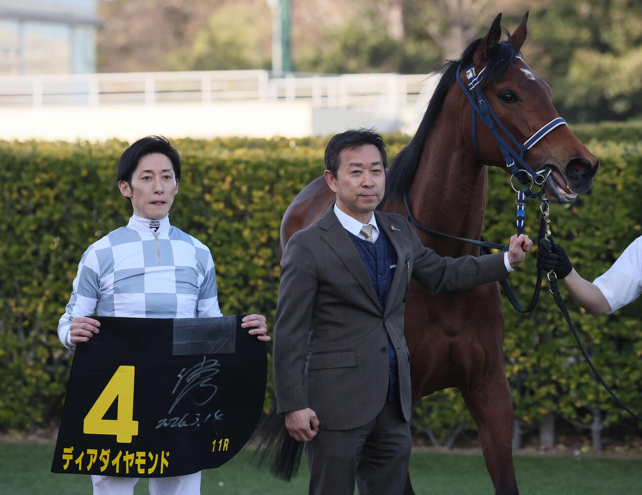 中山11R、アネモネSを制したディアダイヤモンドの口取りをする津村騎手と手塚久師（撮影・丹羽敏通）