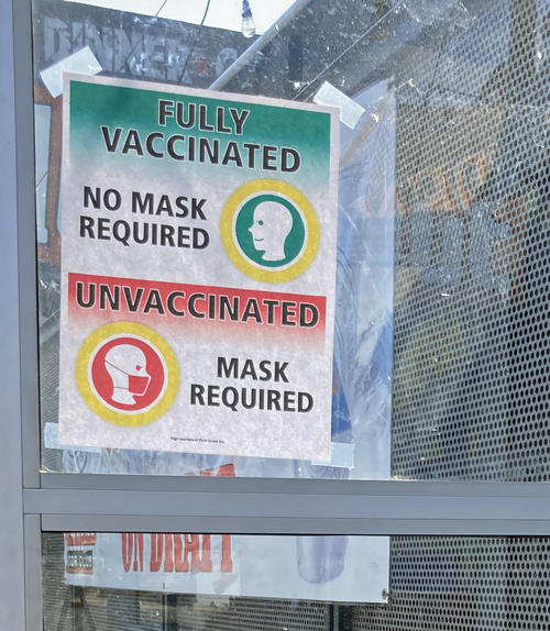 ワクチンを打った人はマスクなし、打っていない人はマスク着用と指示するレストランのサイン。この対策はあまり意味をなさなかったことが立証されました