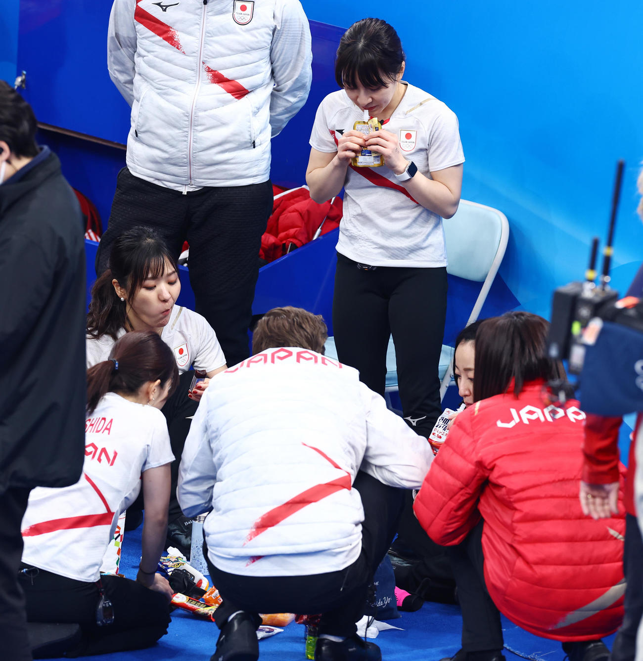日本対カナダ　ハーフタイム、休憩しながら話し合う吉田知（左）らロコ・ソラーレの選手たち（撮影・垰建太）
