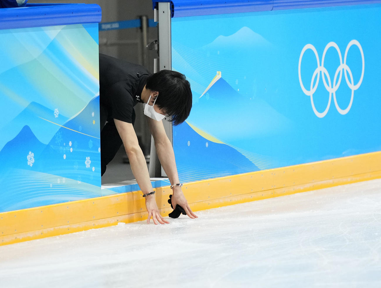 公式練習を終え引き揚げる羽生は、リンクに触れる（撮影・菅敏）